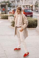 Fashion woman wearing beige coat on the street - 666596021