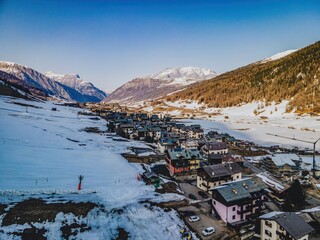A breathtaking aerial perspective of Livigno, captured with precision from a drone. The sprawling...