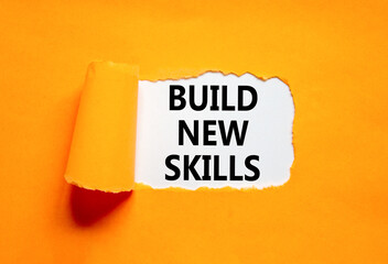 Build new skills symbol. Concept word Build new skills on beautiful white paper. Beautiful orange...