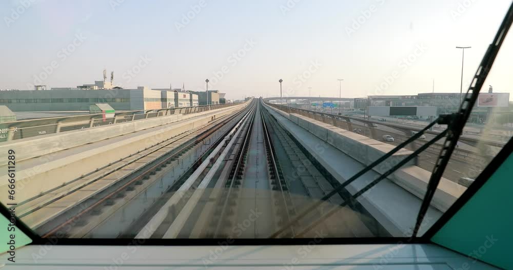 Wall mural Dubai, UAE, United Arab Emirates. Monorail POV Subway train ride in Dubai. Traffic On Street In Dubai.