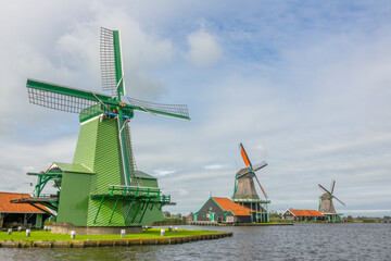 Dutch Vintage Windmills on the River Bank