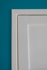 White Wooden Door against Teal Blue Wall