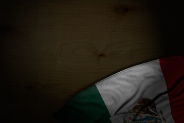 wonderful dark photo of Mexico flag with big folds on dark wood with free space for your text - any holiday flag 3d illustration..