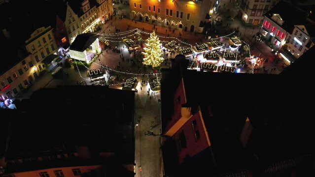 Amazing holidays and celebration concept, christmas market in the Nordic country Estonia, Tallinn. Evening christmas market at old town hall square in Tallinn. Christmas illumination decoration. 