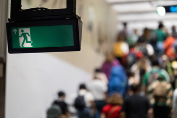 Busy train station with display board with sigh exit
