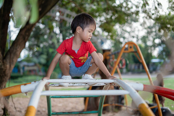  little boy playing in colorful outdoor playground