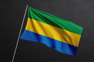 3D Waving flag design. Gabon National flag on black background.