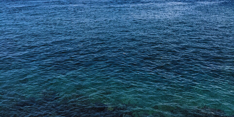 A view of the clear, blue sea taken from a bird's eye view. 