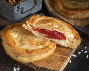Rustico puff pastry from Lecce filled with stuffed with tomato, mozzarella and bechamel sauce