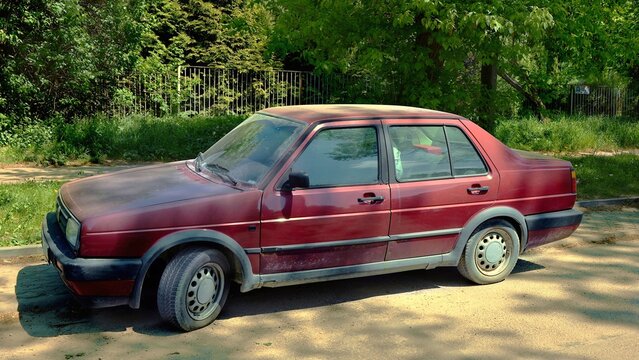 Kielce, Świętokrzyskie, Poland - 2022-05-13 - Volkswagen Jetta , old car from the 90s parked by the road in the background of nature - side front view