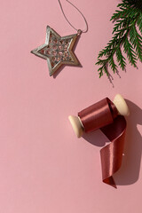 Pink Christmas tree decorations on the pink background. Copy space