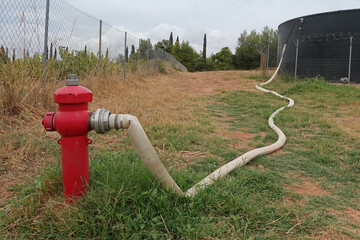 fire hydrant with hose connected to water tank