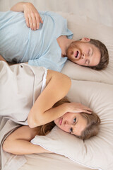 man snoring while his wife is trying to sleep