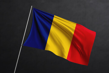 3D Waving flag design. Romania National flag on black background.