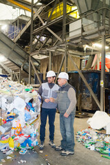 Fototapeta premium sanitation workers in recycling plant