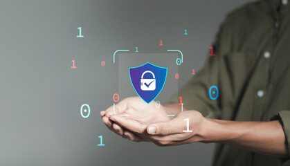 cybersecurity concept, man hand holding padlock icon with shield for protecting cyber privacy...