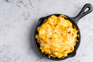 Homemade baked mac and cheese pasta  in cast iron pan