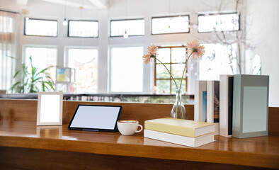 Coffee drink with tablet computer and book, photo fram on wooden counter, interior decoration for a...