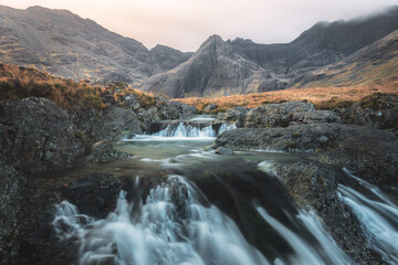 Moody, dramatic mountain and waterfall landscape of the Fairy Pools and Black Cuillins at Glen Brittle on the Isle of Skye in the Scottish Highlands, Scotland.