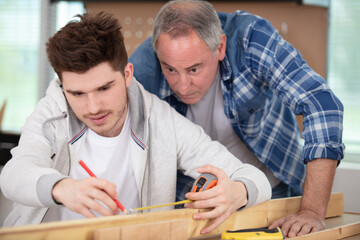 carpenter with apprentice in training period