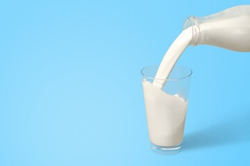 Pouring fresh tasty milk in glass