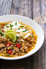 Yunnan rice noodle soup on wooden table

