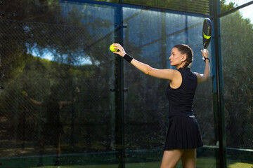 Padel tennis player with racket. Woman athlete with paddle racket on court outdoors. Sport concept....