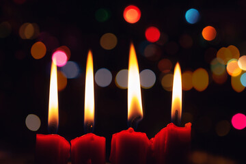 Close up of red four christmas candle with christmas light bokeh in the night time wirh copy space