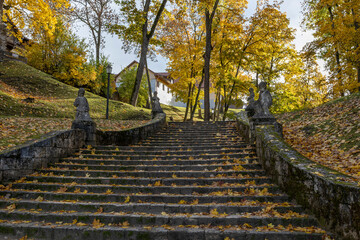 Park stairs with stone statues in autumn. Cesis, Latvia.