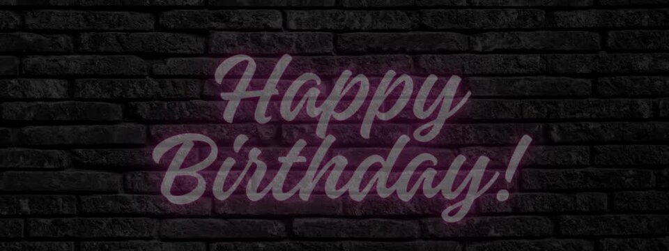 Happy birthday neon text with a dark grey brick background 