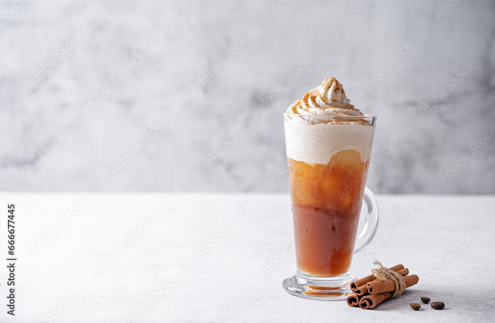 Wall mural pumpkin spice latte with whipped cream and cinnamon in a glass