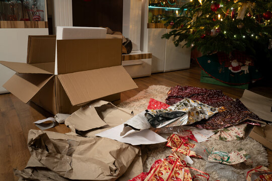 It's Christmas Eve. The presents have been unwrapped. In the Christmas living room there is a chaos of wrapping paper and boxes under the Christmas tree. Authentic image from private party.