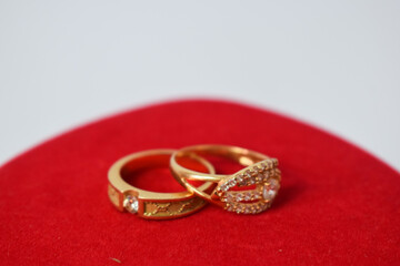 Close Up Golden ring with diamond on red carpet Background