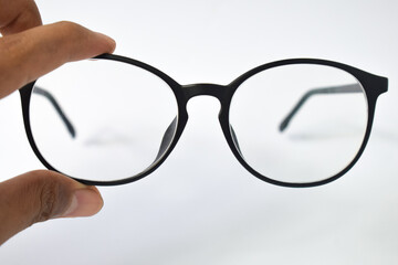 Hand hold Black frame eyeglasses unisex isolated on white background 