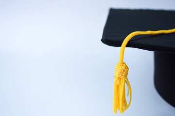 Close-up Black Graduation Hat and Yellow Tassel isolated on white background