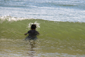 Asian little boy having fun playing in the sea, Layan Beach, Phuket, Thailand