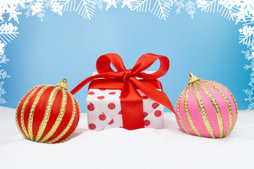 Merry Christmas and Happy New Year. Realistic gift box with polka dot and bow with striped balls on snow on blue background with snowflakes. Christmas poster, holiday banner, greeting card. Copy space