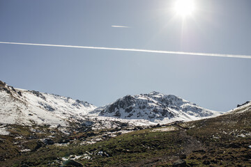 Winter mountain landscape: snow-covered mountain valley, clear blue sky. High-quality photo for website design, postcards, banners, and travel product advertising