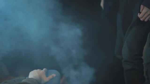 Close-up shot of an injured man with a cigarette in his mouth getting punched, movie-like scene set-up. HD footage.