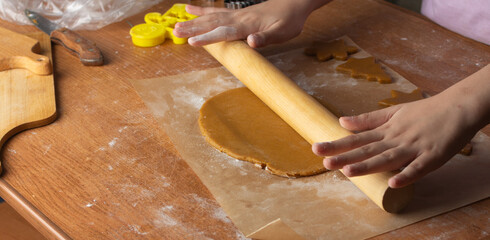 rolling out dough for gingerbread, homemade holiday baking.