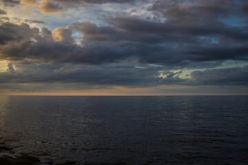 Long exposure image of dramatic sky seascape in sunset scenery background