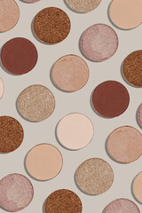 Pattern with refill eye shadow beige brown natural color on neutral colored background. Makeup palette eyeshadows powder, shine and matte, minimal aesthetic photo pastel colored, top view, flat lay