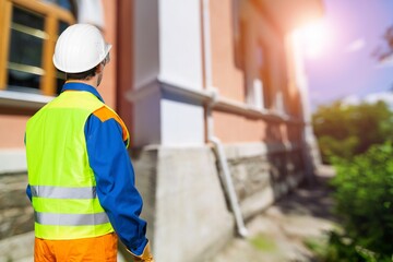 Builder inspection checking material in construction.