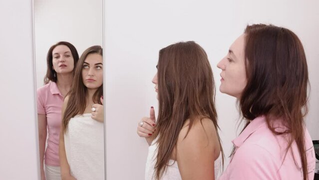 Problem areas, Beauty appointment, Facial diagnosis. The beautician is shown the areas of her face that require treatment by the female client using a mirror.