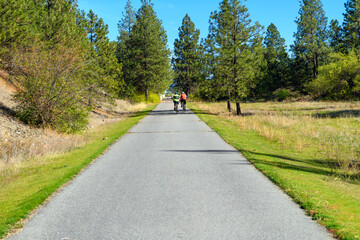 Two bicyclists ride their bikes along the Centennial Trail near the Idaho Washington border in the...