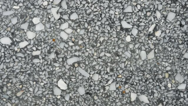 Black granite stone background a striking and enduring canvas. This textured surface, characterized by its deep, velvety black speckles, adds a touch of elegance and timeless. High quality 4k footage