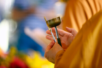 Nun at Buddhist ceremony sounding Buddhist brass bell, Tu An Buddhist temple, Saint Pierre en Faucigny, Haute-Savoie, France