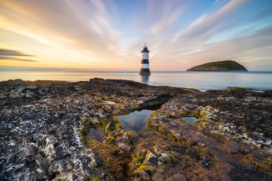 Trwyn Du Lighthouse at sunset in summer, Beaumaris, Wales, Great Britain