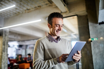 Modern young businessman using a tablet in the office