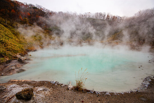 Steaming turquoise blue volcanic pond of Hell Valley, Noboribetsu, Hokkaido, Japan
